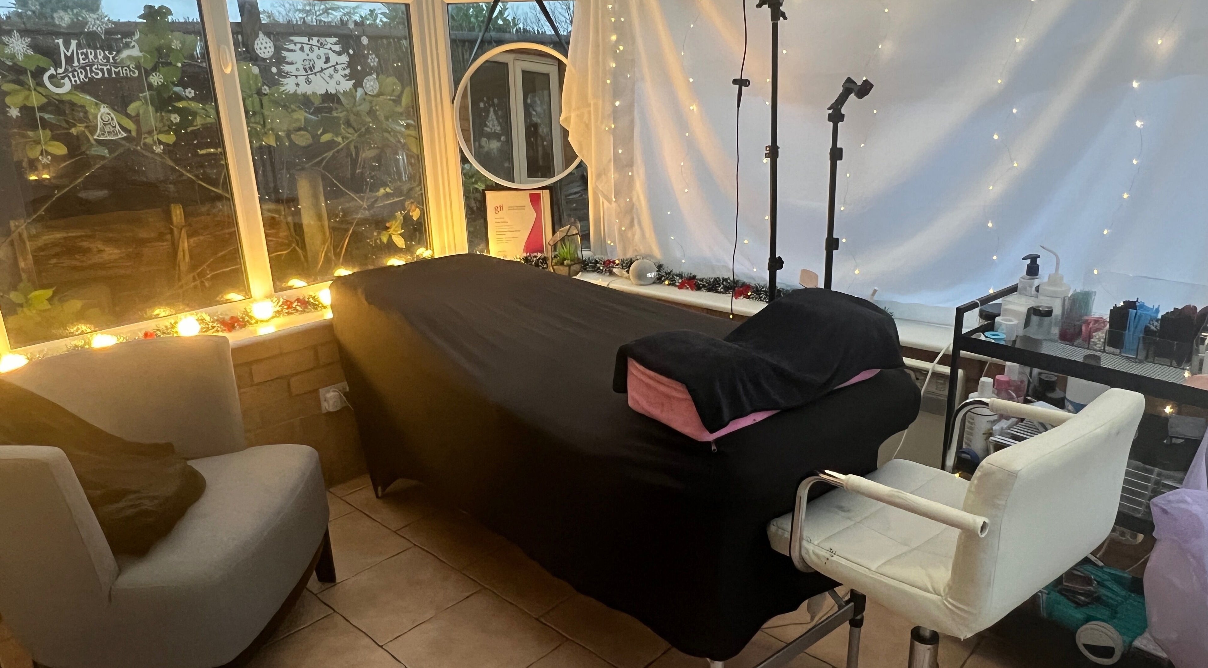 Tranquil treatment room at VLK Beauty UK - Salford, Salford, England, GB, with festive decor and a comfortable setup.