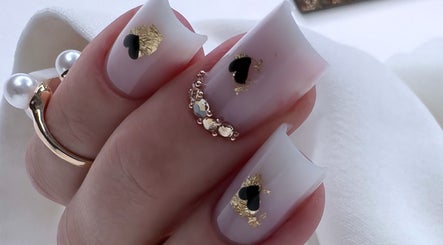 Stylish nail art with black hearts and gold flakes at Silvia Vasiliu Nails, STOKE-ON-TRENT, England, GB.