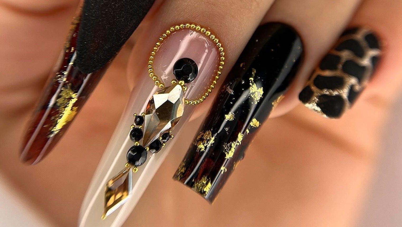 Elegant nail art featuring gold accents at Silvia Vasiliu Nails, STOKE-ON-TRENT, England, GB.