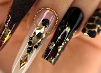 Elegant nail art featuring gold accents at Silvia Vasiliu Nails, STOKE-ON-TRENT, England, GB.