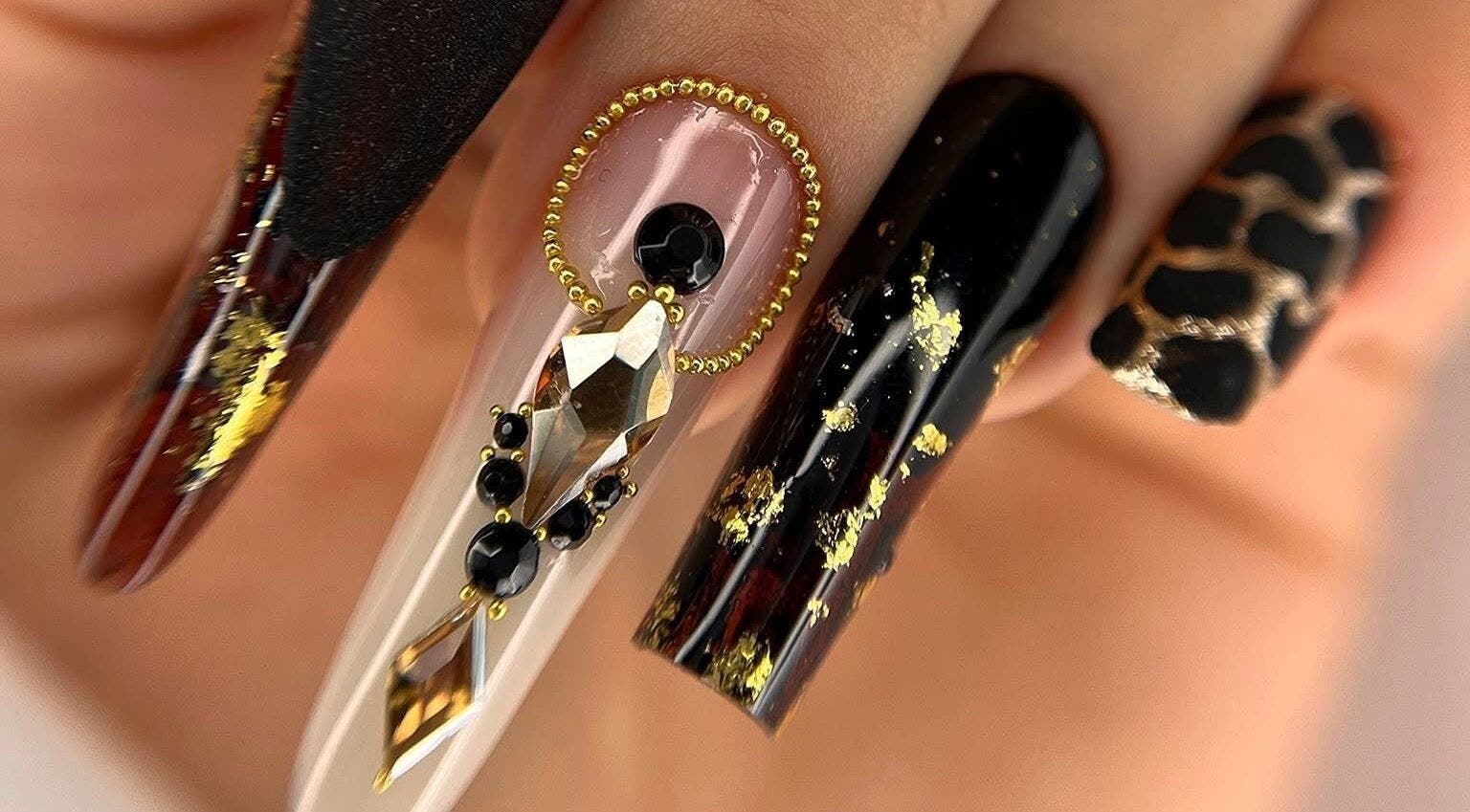 Elegant nail art featuring gold accents at Silvia Vasiliu Nails, STOKE-ON-TRENT, England, GB.
