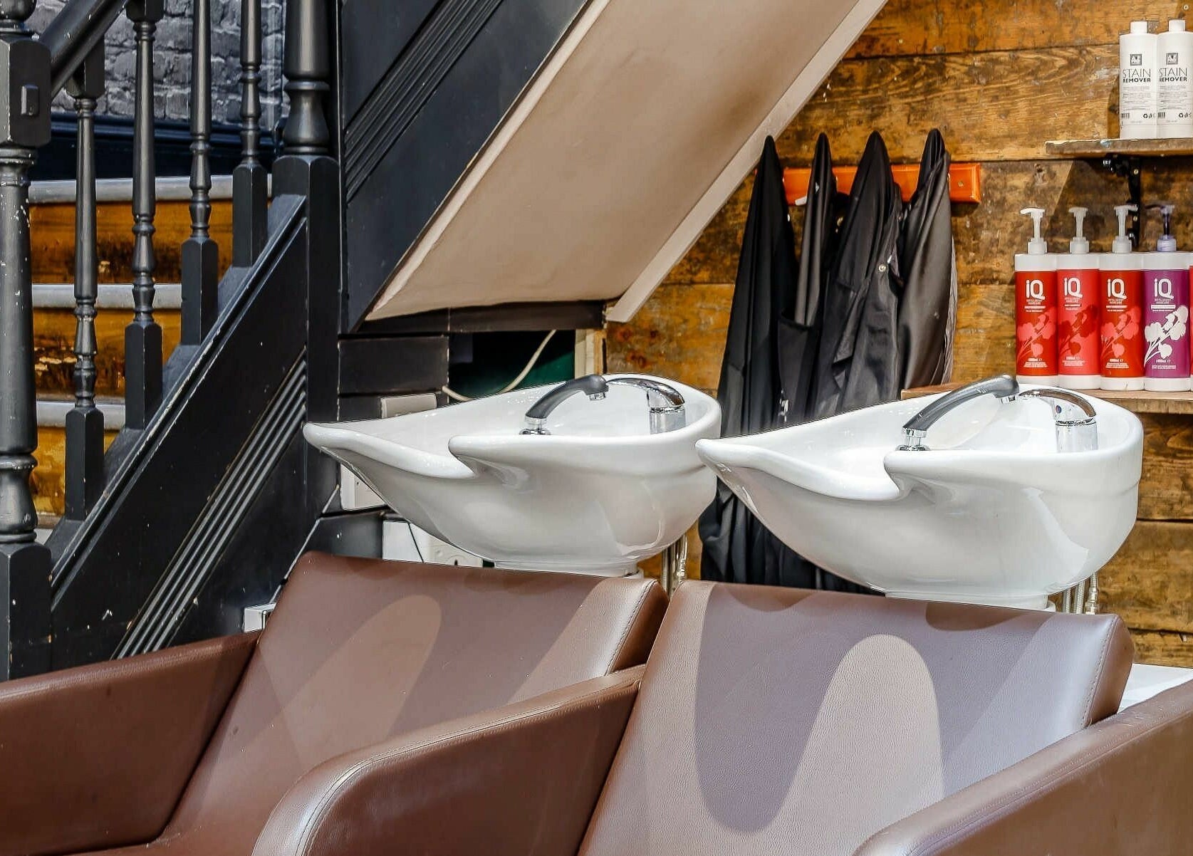 Sleek wash station with brown chairs at Slix Salon, Swansea, Wales, GB. Styled for comfort and luxury.