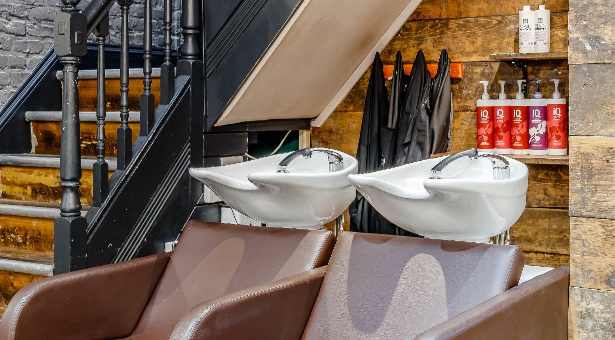 Sleek wash station with brown chairs at Slix Salon, Swansea, Wales, GB. Styled for comfort and luxury.