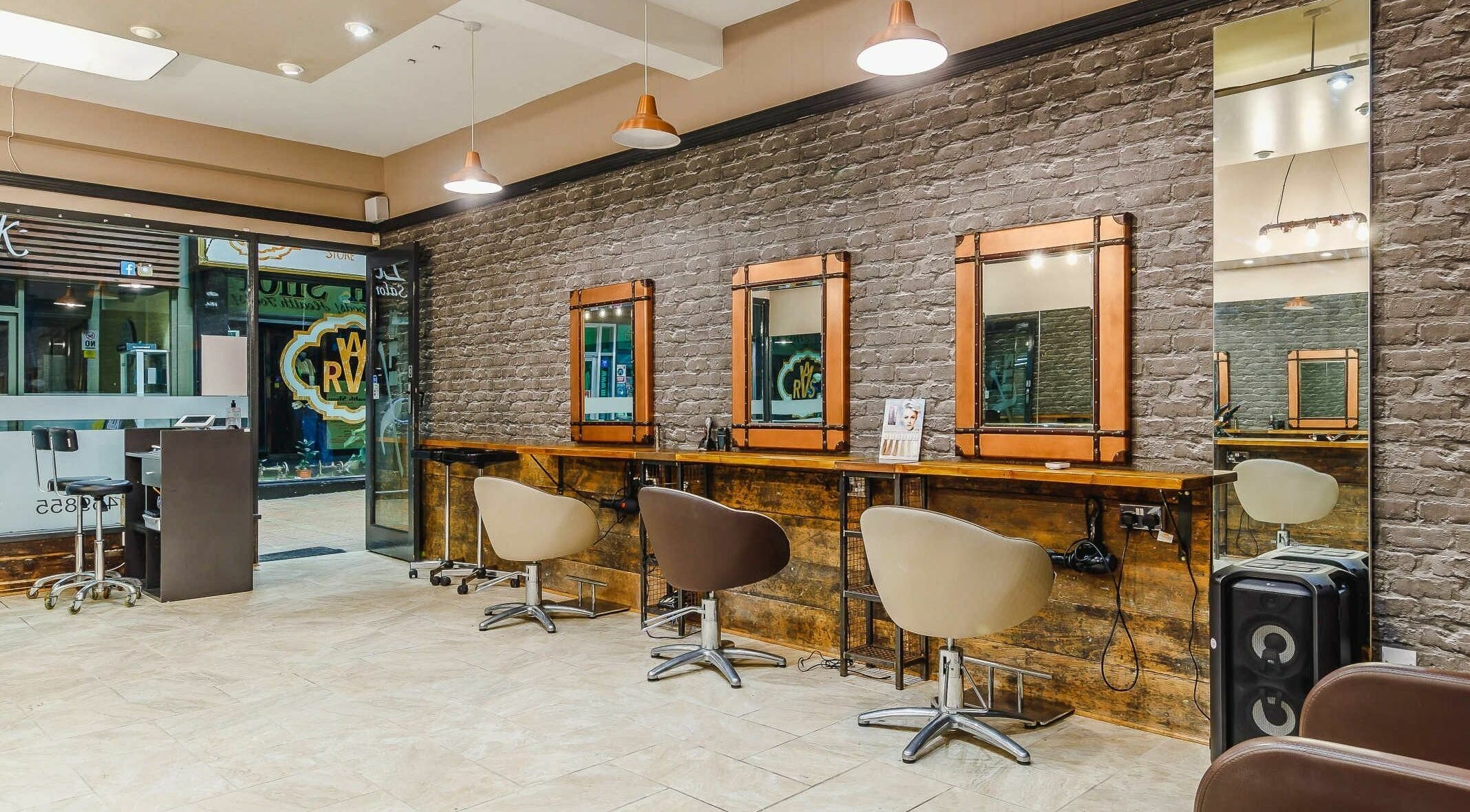 Elegant hair styling stations at Slix Salon, Swansea, Wales, GB, featuring rustic decor and modern design.