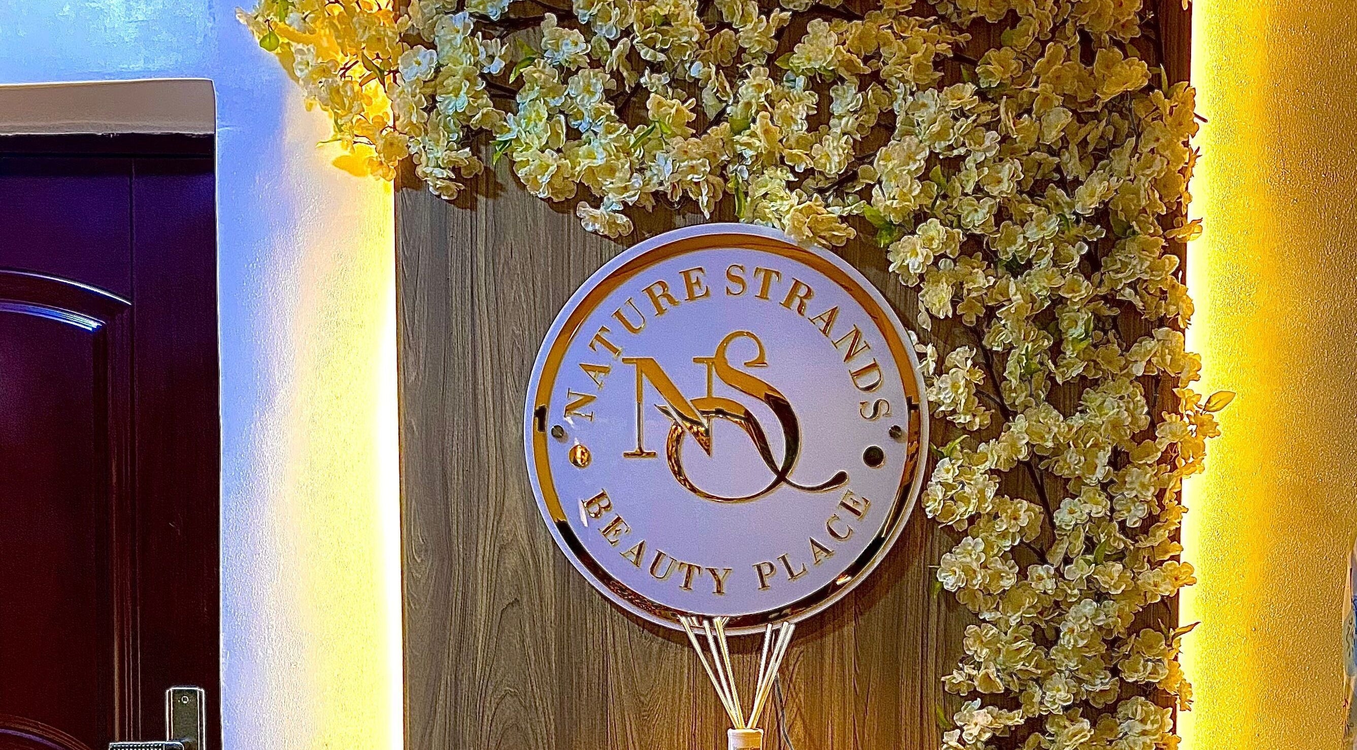 Nature Strands Hair Clinic Abuja sign with floral decor, Abuja, Federal Capital Territory, NG.