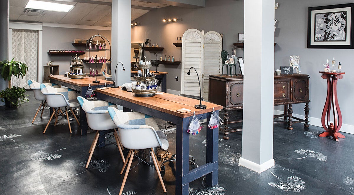 Elegant interior of Top Coat Nails and Spa in Purcellville, Virginia, US, showcasing modern nail stations.