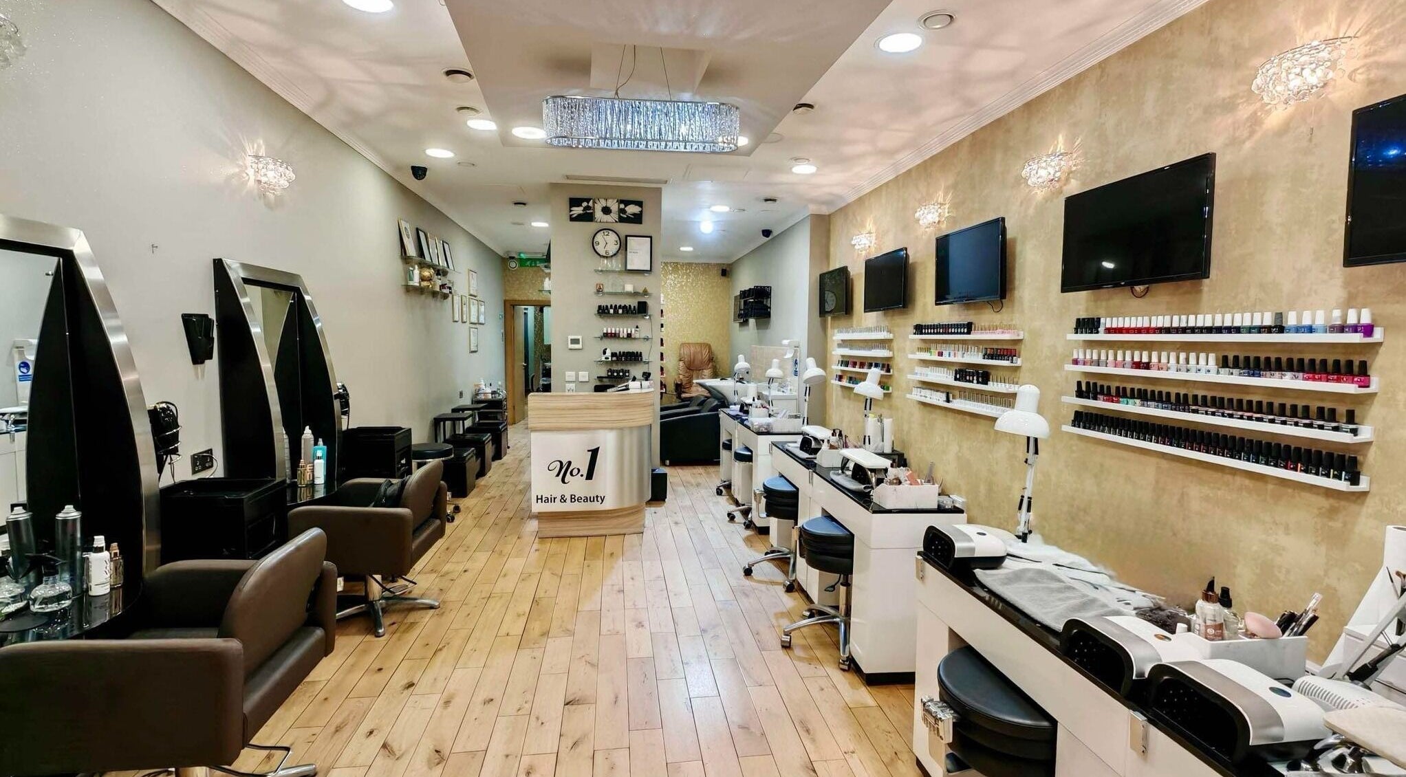 Elegant interior of No1 Hair & Beauty salon in London, England, GB, showcasing nail stations and styling chairs.