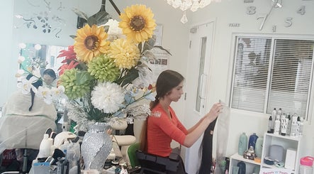 Inside Need a Makeover Hair, Dudley, England, GB, vibrant floral decor enhances serene beauty atmosphere.