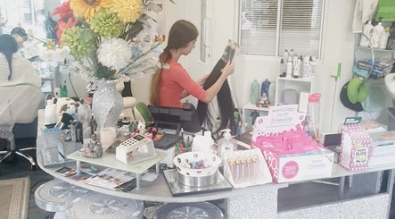 Colorful salon counter at Need a Makeover Hair, Dudley, England, GB with stylist organizing hair products.