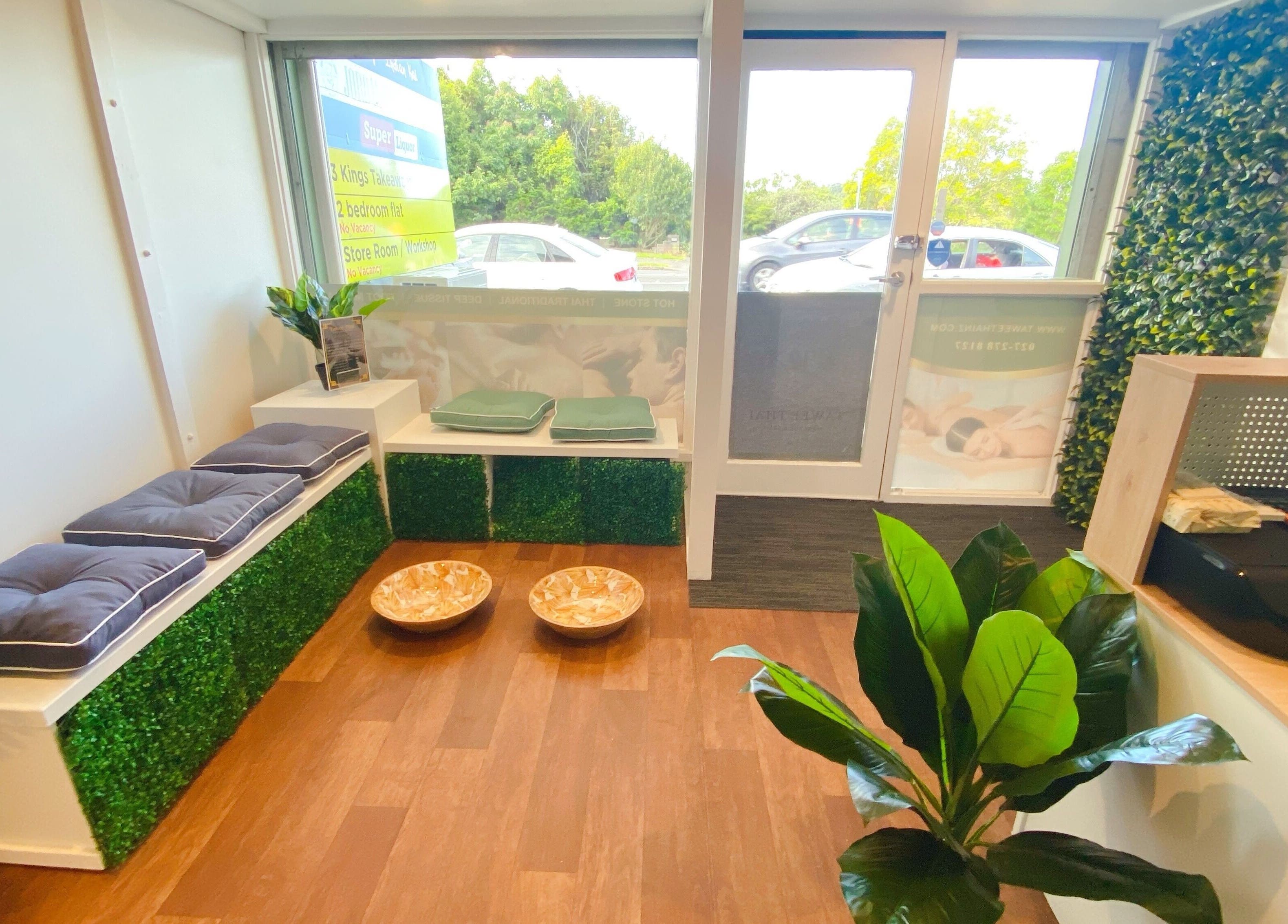 Inviting entryway of Tawee Thai Massage and Spa in Auckland, Auckland, NZ with seating and greenery.