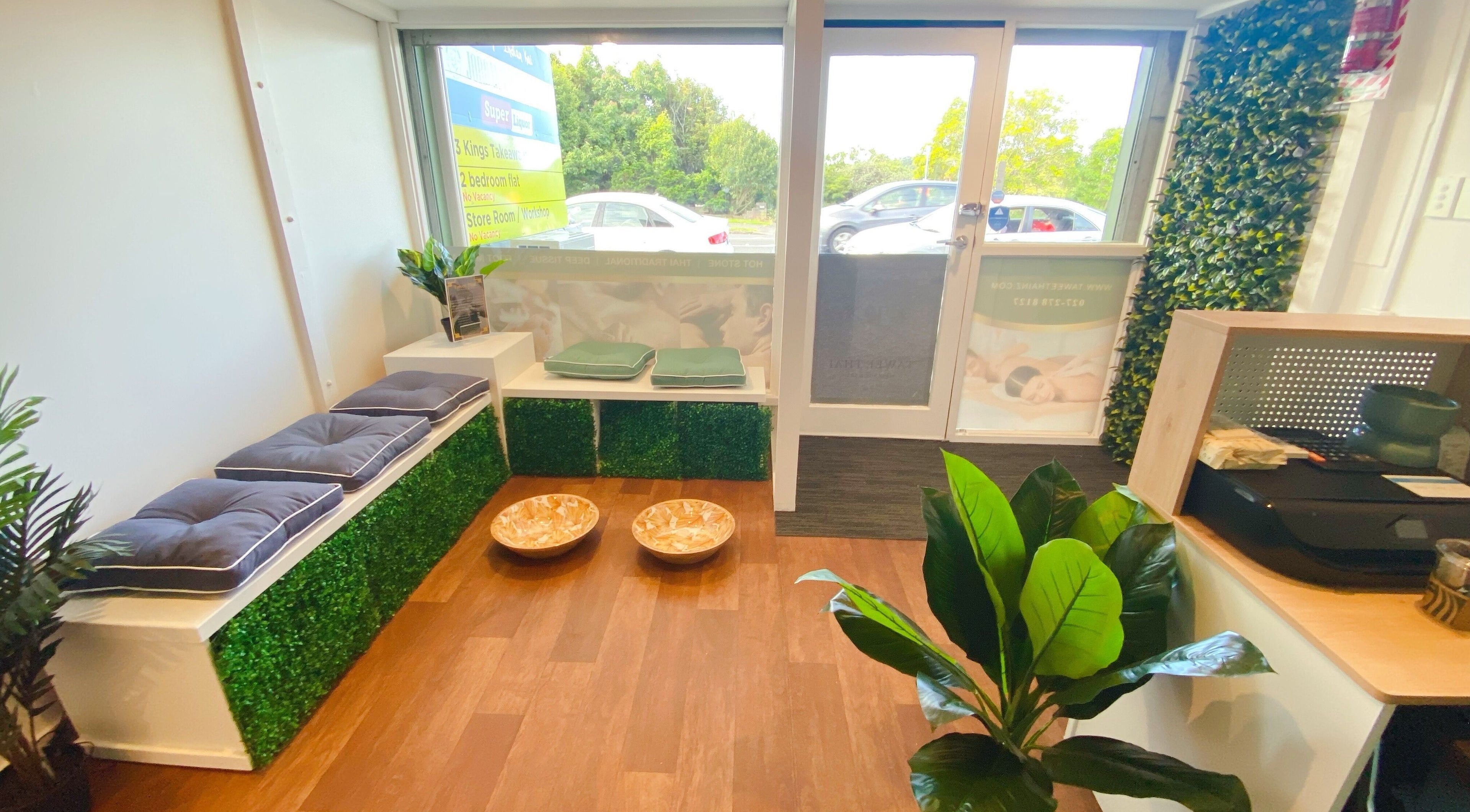 Inviting entryway of Tawee Thai Massage and Spa in Auckland, Auckland, NZ with seating and greenery.