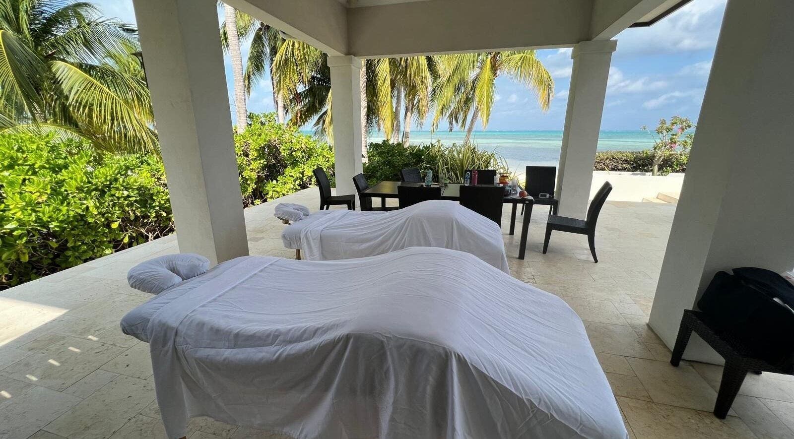 Outdoor massage setup at Molly's Hair and Spa Cayman, Grand Cayman, KY with ocean view.
