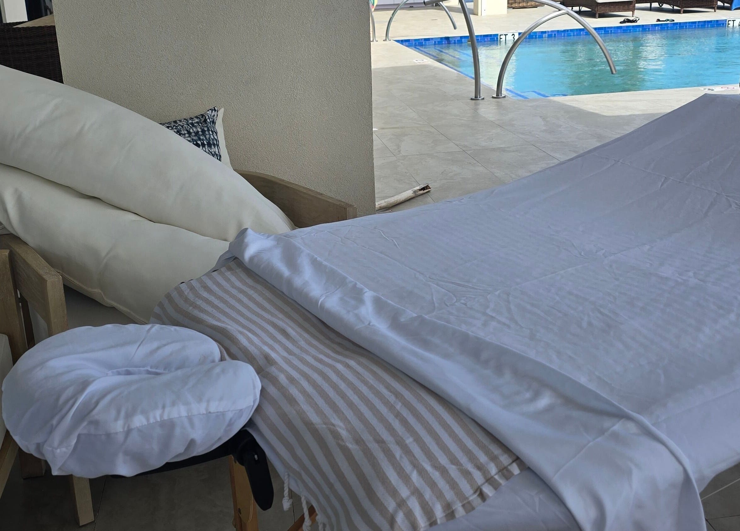 Relaxing poolside massage setup at Molly's Hair and Spa Cayman, Grand Cayman, KY for ultimate relaxation.