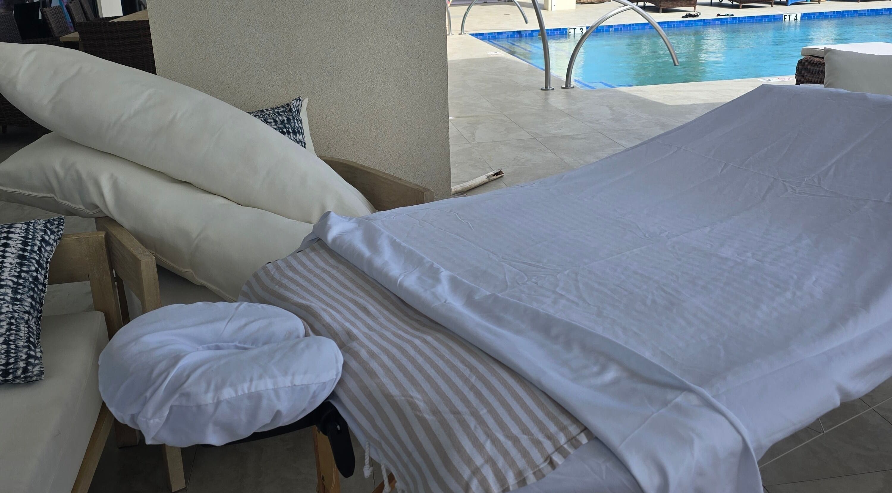 Relaxing poolside massage setup at Molly's Hair and Spa Cayman, Grand Cayman, KY for ultimate relaxation.