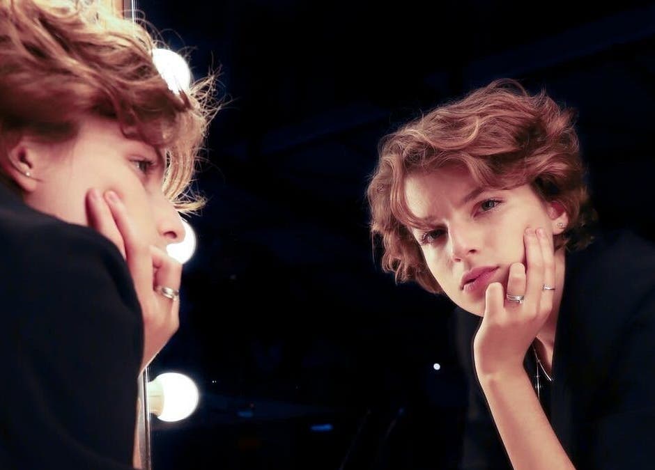 A person gazing into a mirror at Maxine's Hair Care, Kallangur, Queensland, AU.