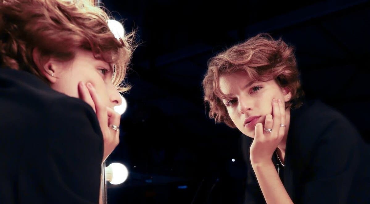 A person gazing into a mirror at Maxine's Hair Care, Kallangur, Queensland, AU.