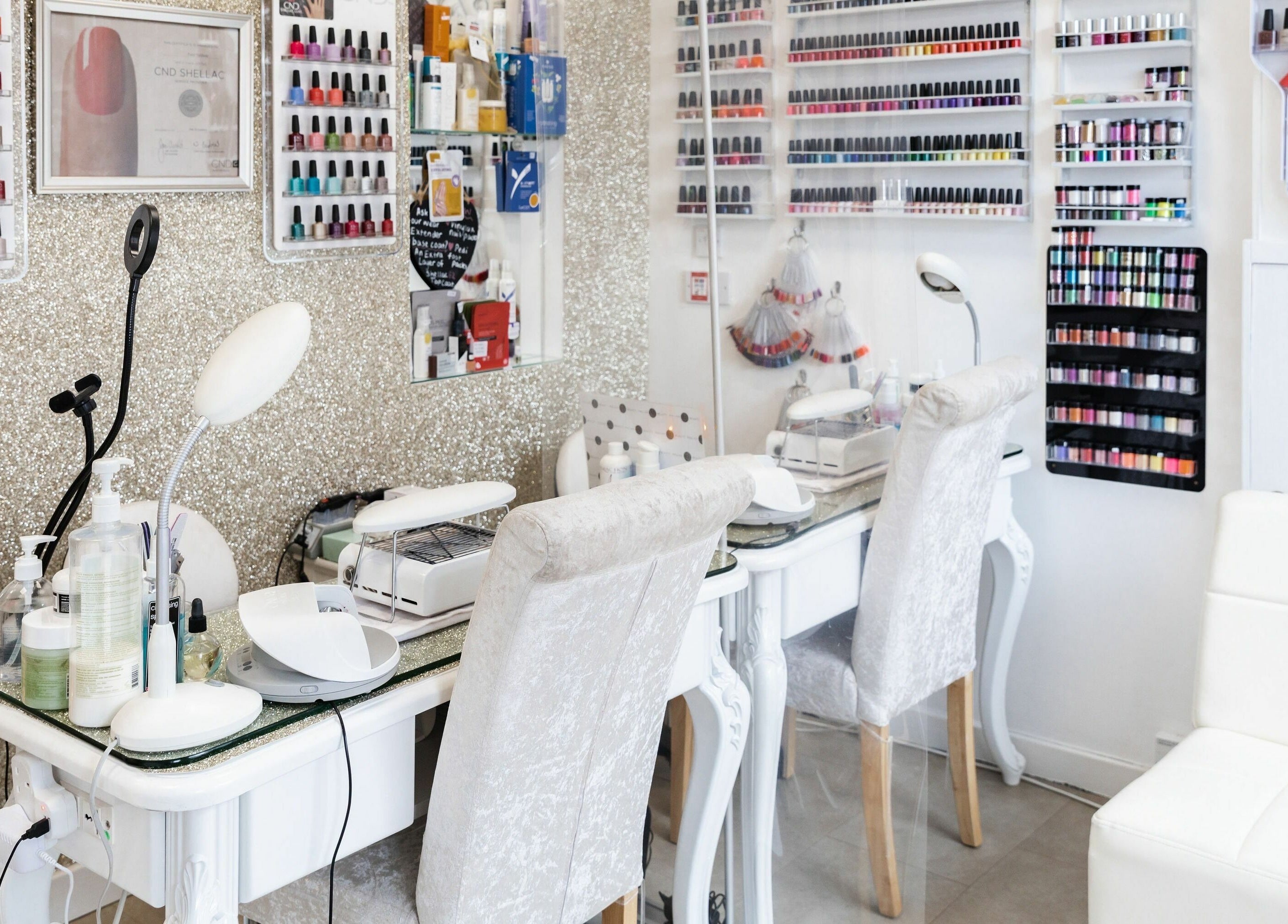 Interior of Pallas Beauty nail salon in Dundee, Scotland, GB with manicure stations and polish displays.