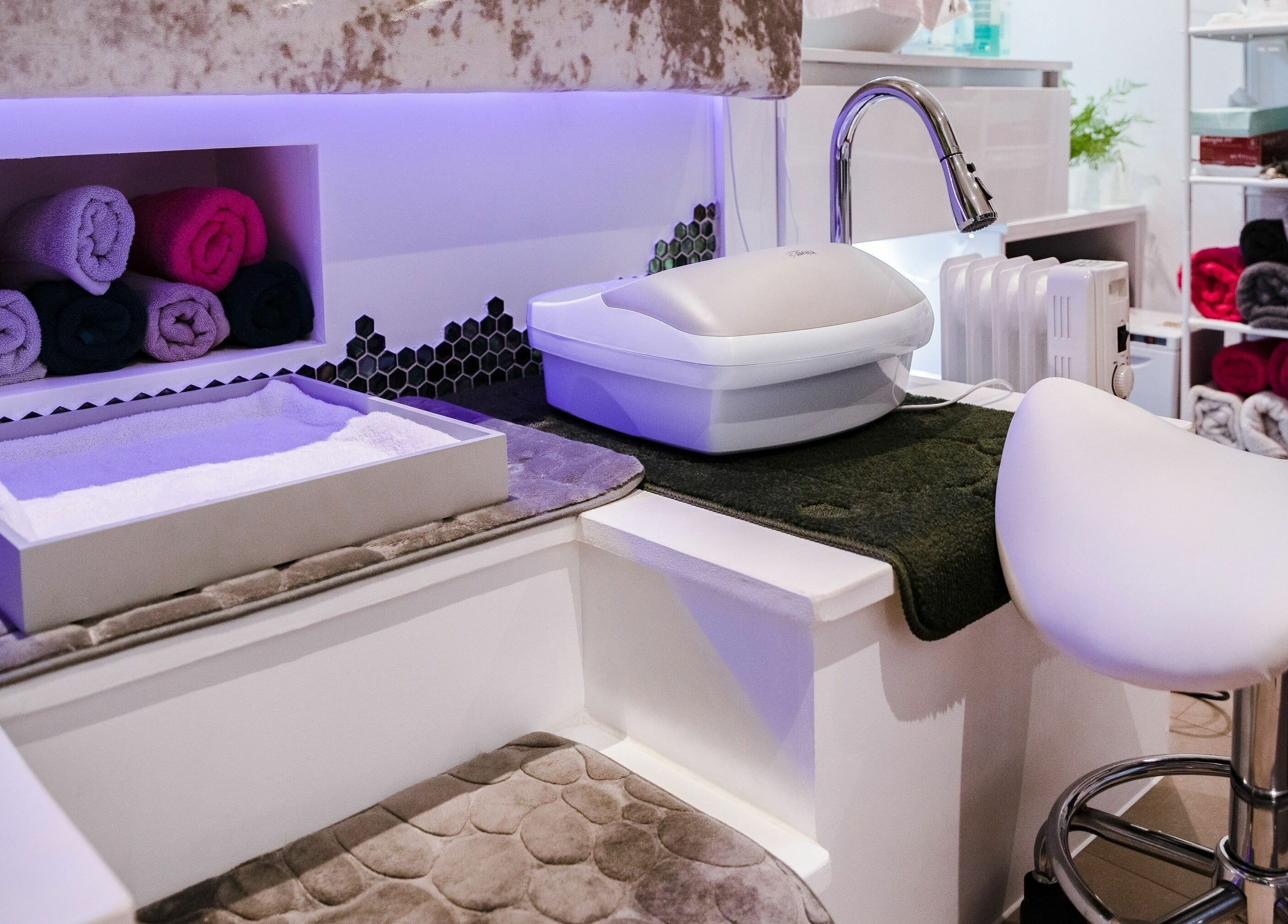 Luxurious nail spa setup featuring plush seating at Pallas Beauty in Dundee, Scotland, GB.