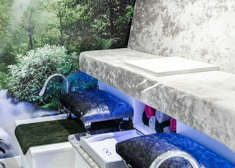 Luxurious spa setting at Pallas Beauty, Dundee, Scotland, GB with plush velvet seating and nature-inspired decor.