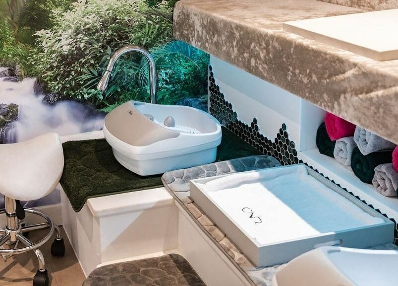 Relaxing pedicure station at Pallas Beauty, Dundee, Scotland, GB with a lush forest mural backdrop.