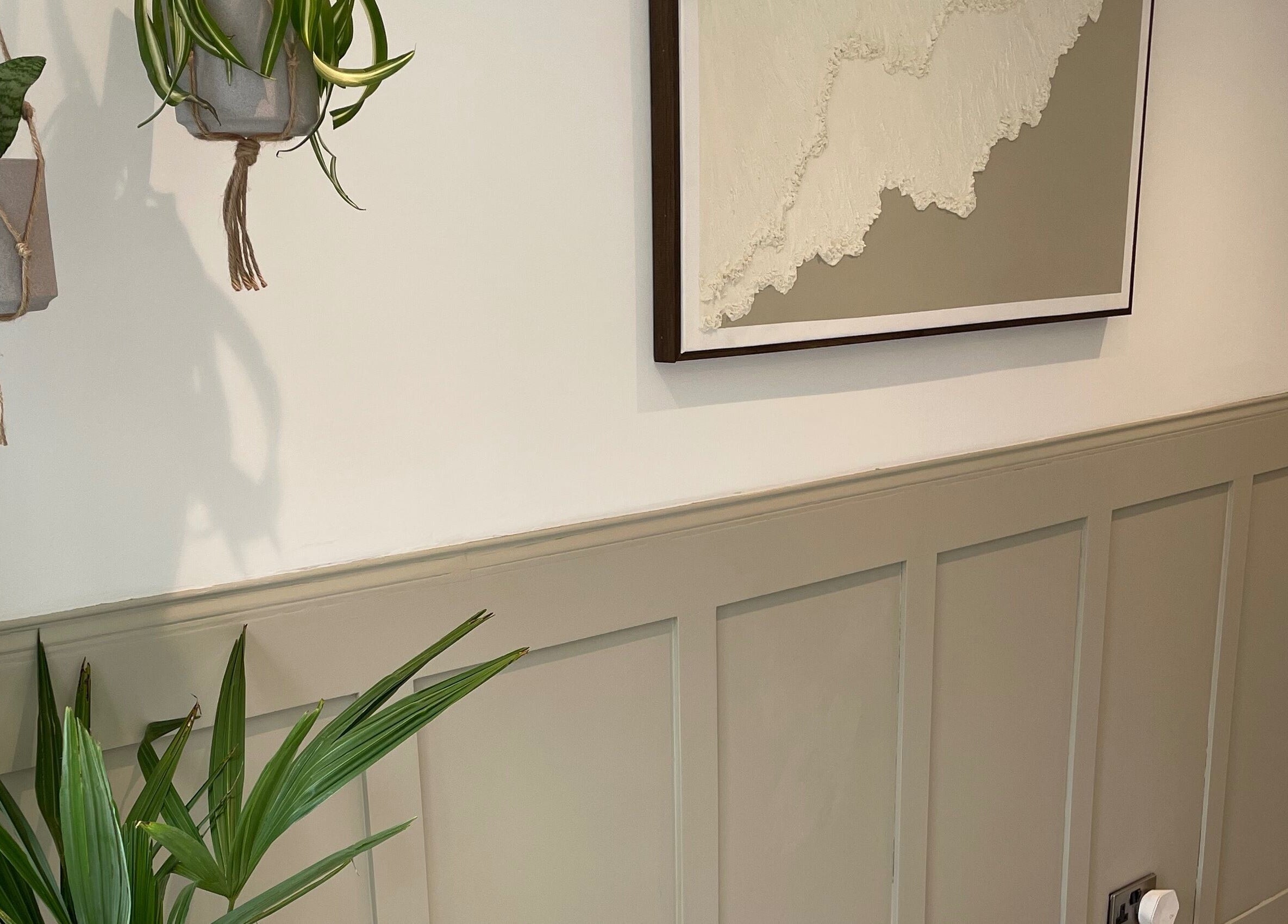 Elegant wall art and plants at Amy Newton Hair Design, Cheswick Green, England, GB.