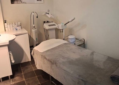 Relaxing treatment room at Hornsby Beauty Salon, Hornsby, New South Wales, AU, with massage table and skincare products.