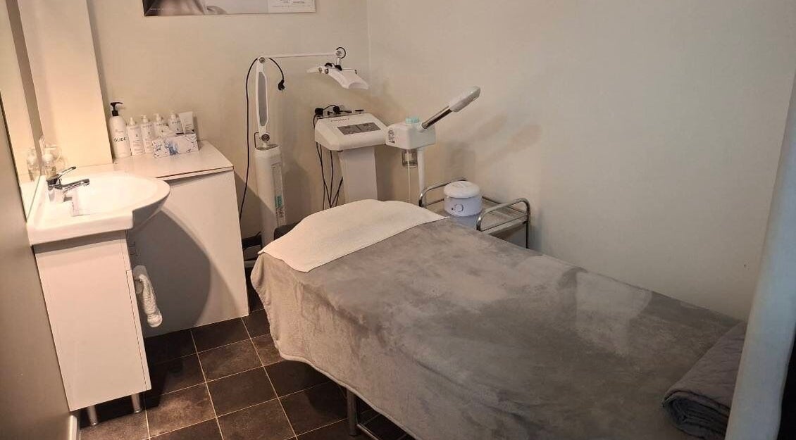 Relaxing treatment room at Hornsby Beauty Salon, Hornsby, New South Wales, AU, with massage table and skincare products.