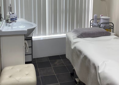 Treatment room at Hornsby Beauty Salon in Hornsby, New South Wales, AU featuring a bed and sink.