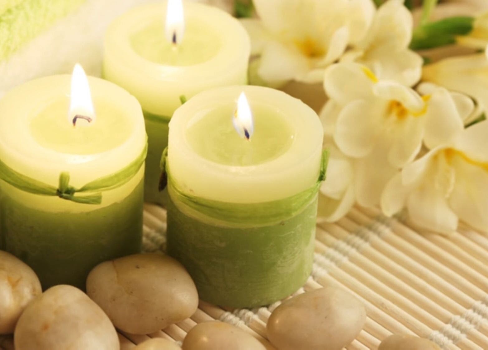 Soothing candles and flowers at CamelliasBodyMassage in Christchurch, NZ, enhancing relaxation and ambiance.
