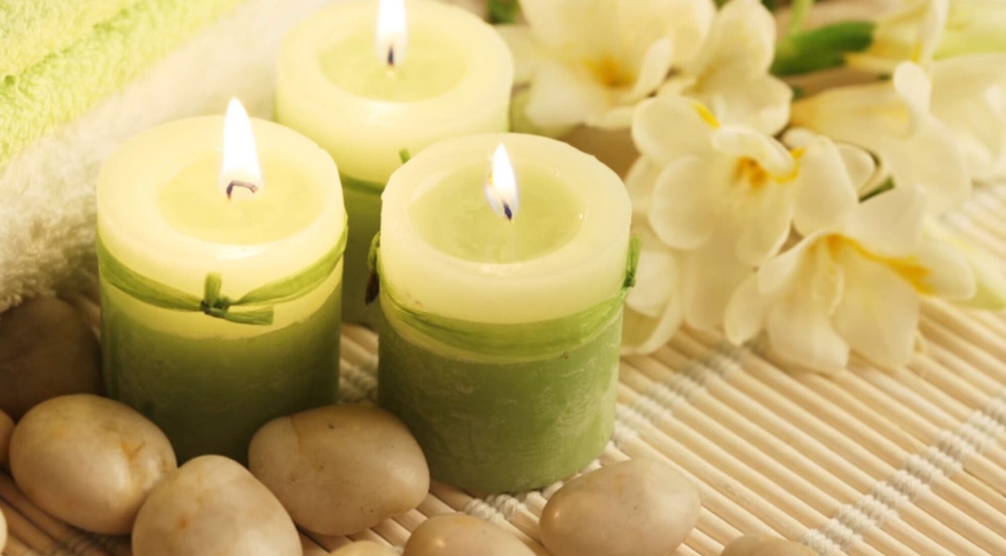 Soothing candles and flowers at CamelliasBodyMassage in Christchurch, NZ, enhancing relaxation and ambiance.