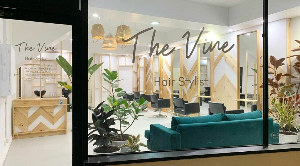 The Vine Hairstylist interior in Melbourne, Victoria, AU, featuring sleek chairs and modern wooden decor.