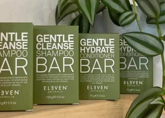 Eco-friendly shampoo and conditioner bars at The Vine Hairstylist, Melbourne, Victoria, AU, with lush greenery.