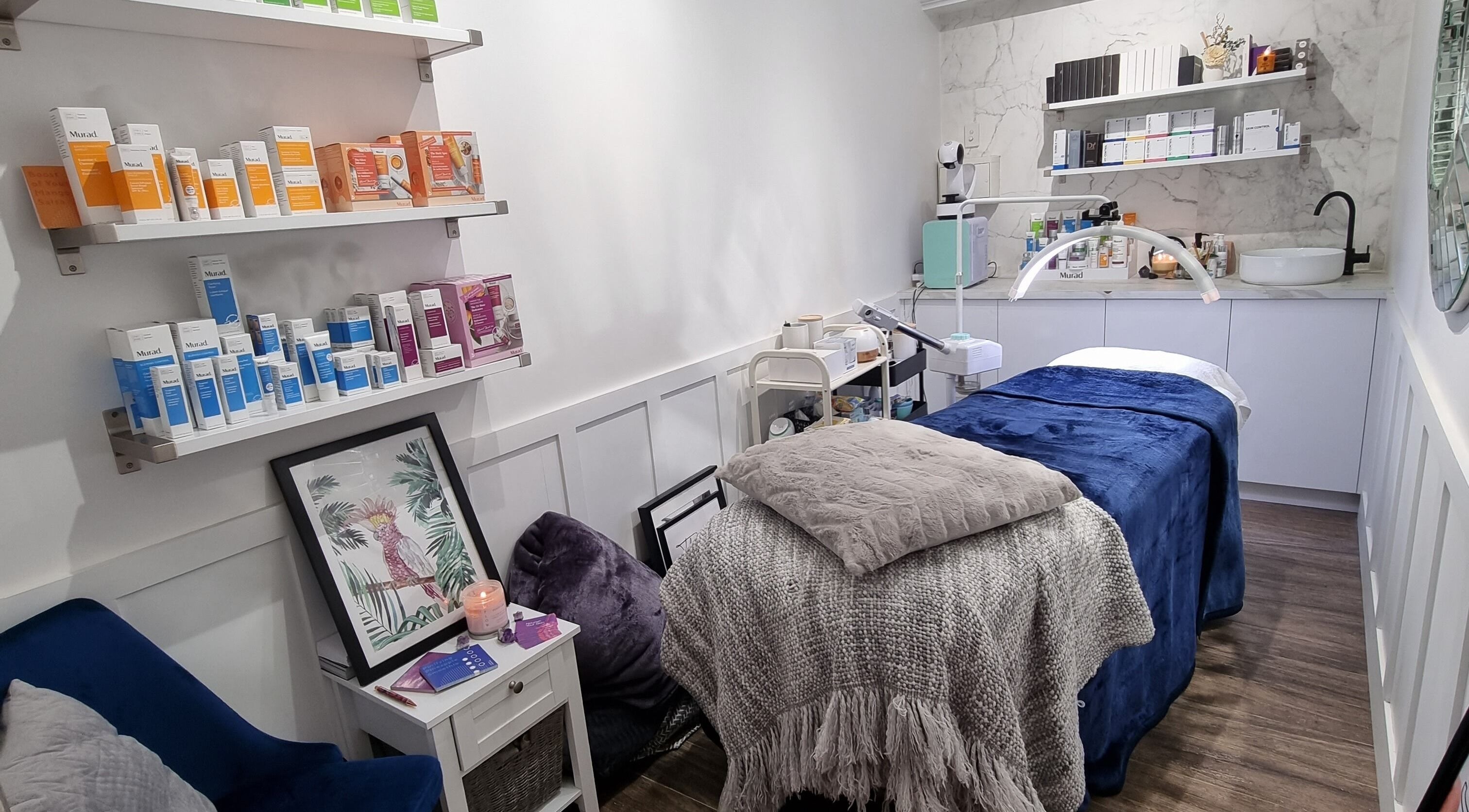 Cozy treatment room at Therapy Beauty, Albion, Queensland, AU, featuring products and comforting decor.