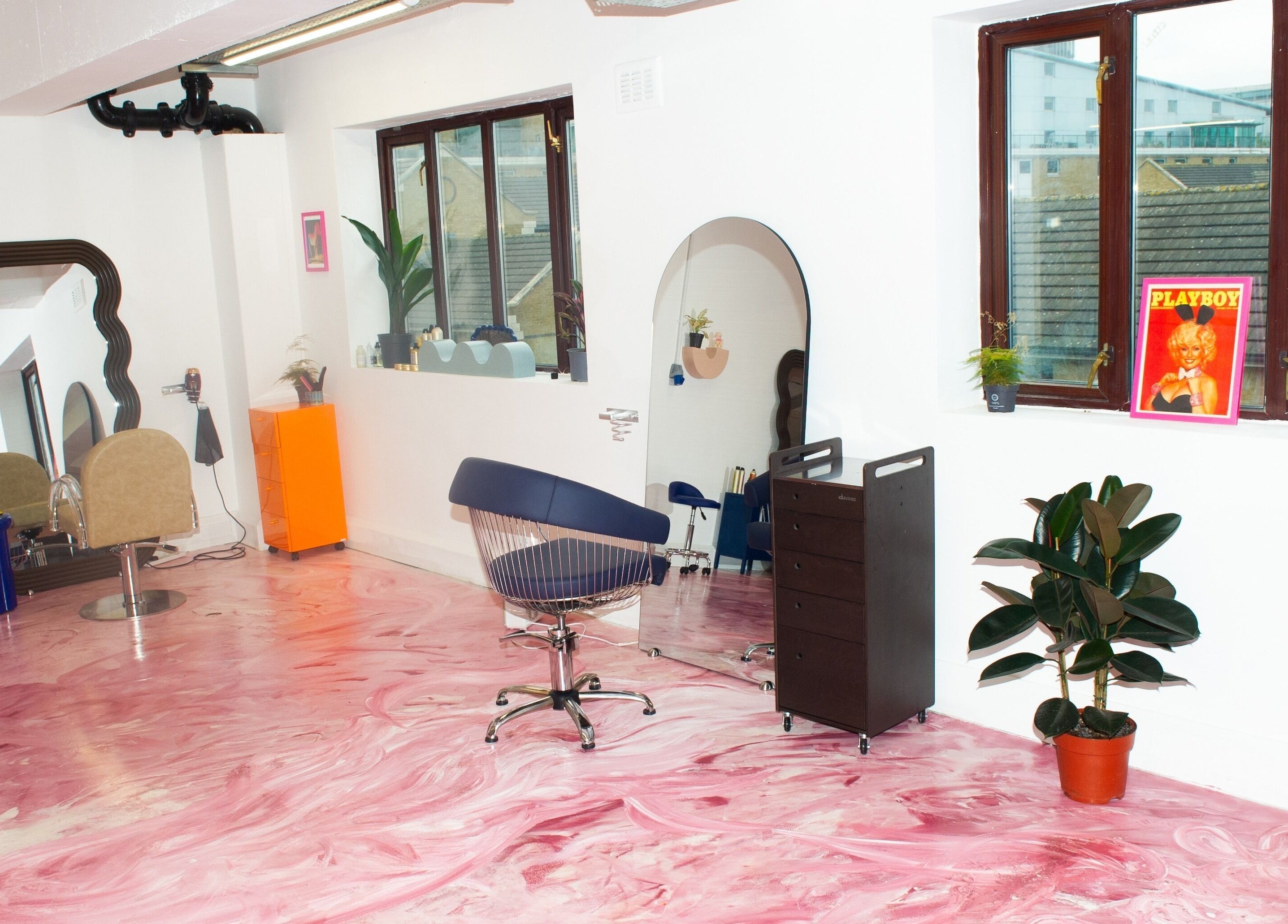 Vibrant interior of Shag East in London, England, GB with pink marbled floor and stylish mirrors.