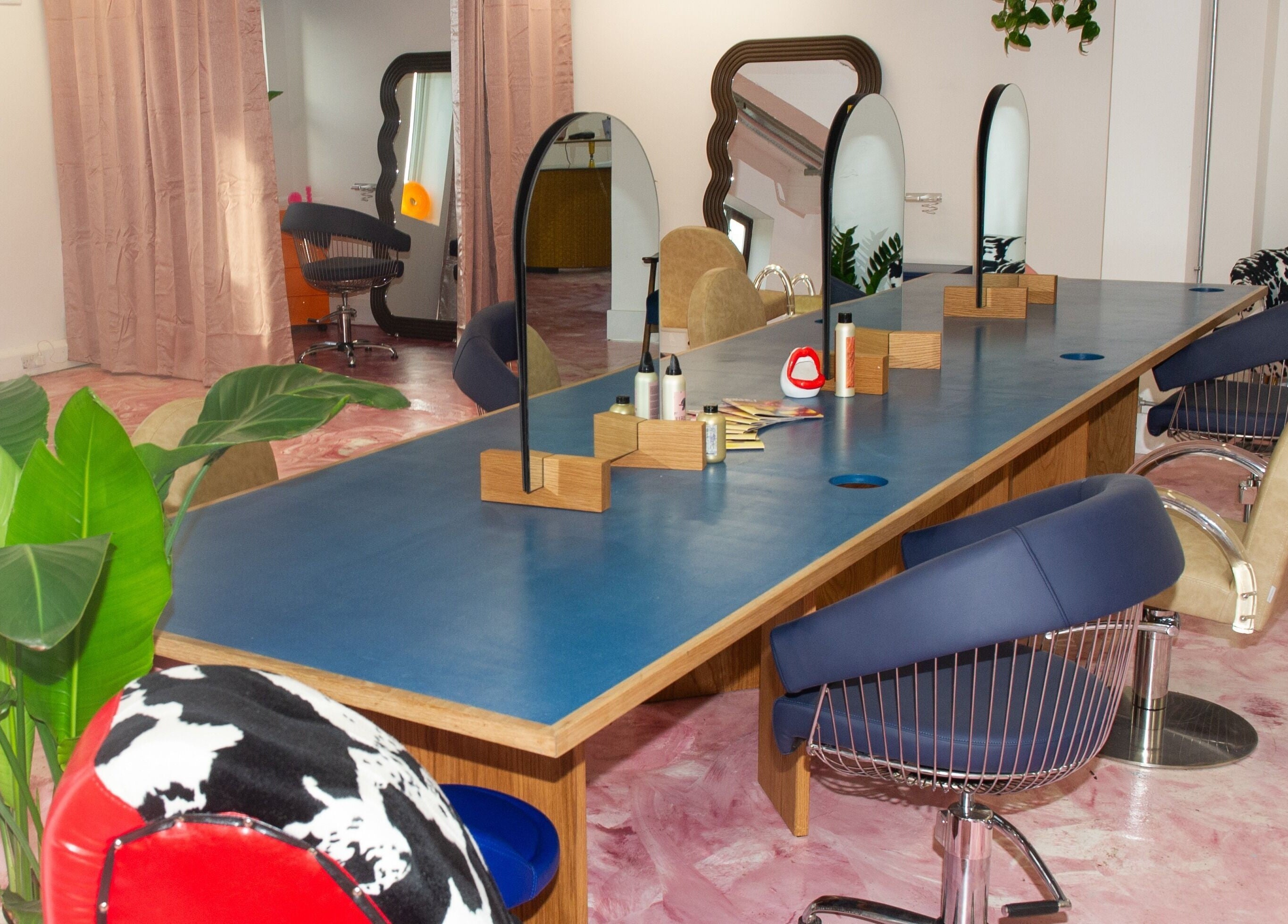 Chic and colorful interior of Shag East in London, England, GB showcasing beauty stations and decor.