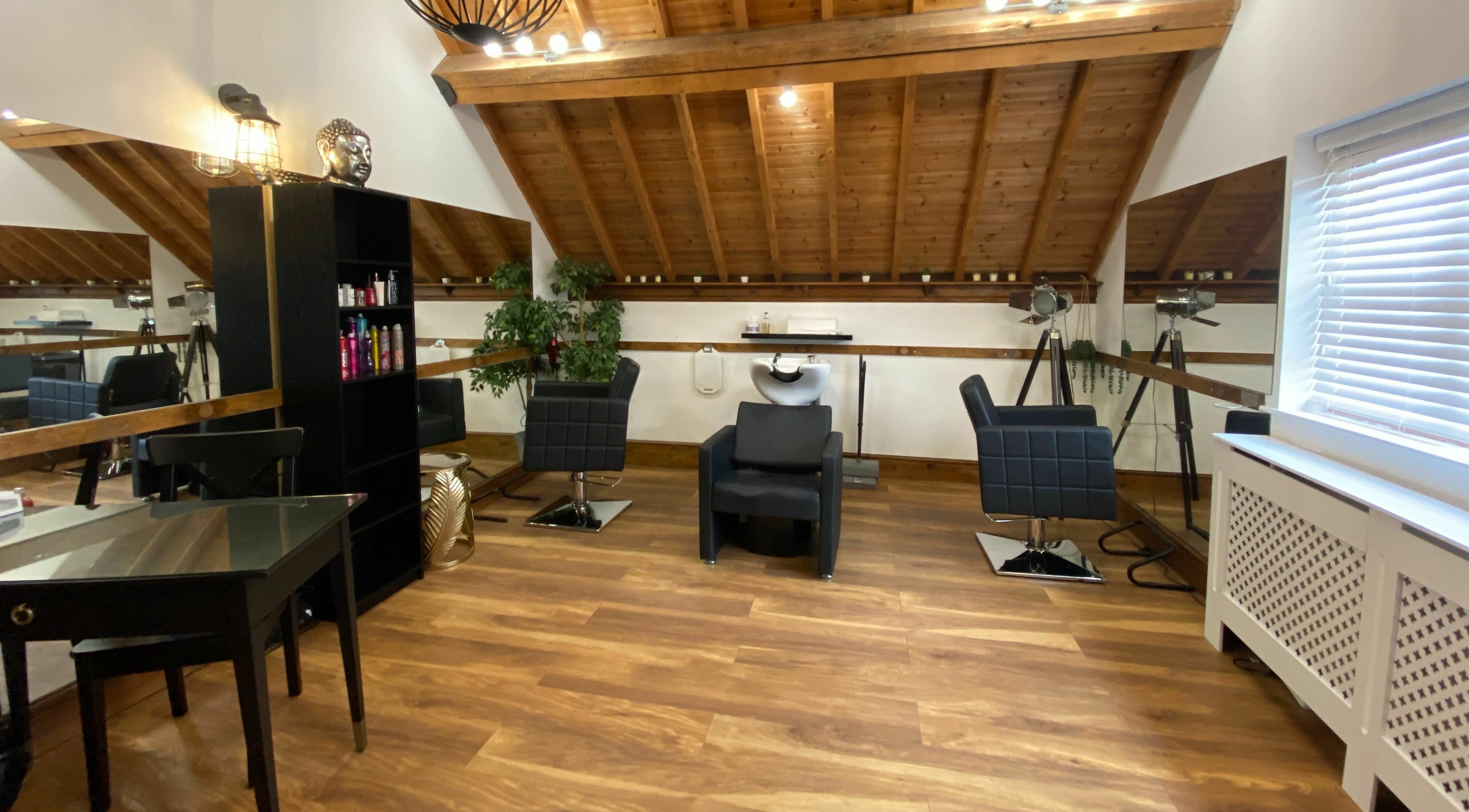 Chic salon interior at The Loft Solihull, Earlswood, England, GB, featuring modern styling chairs and mirrors.