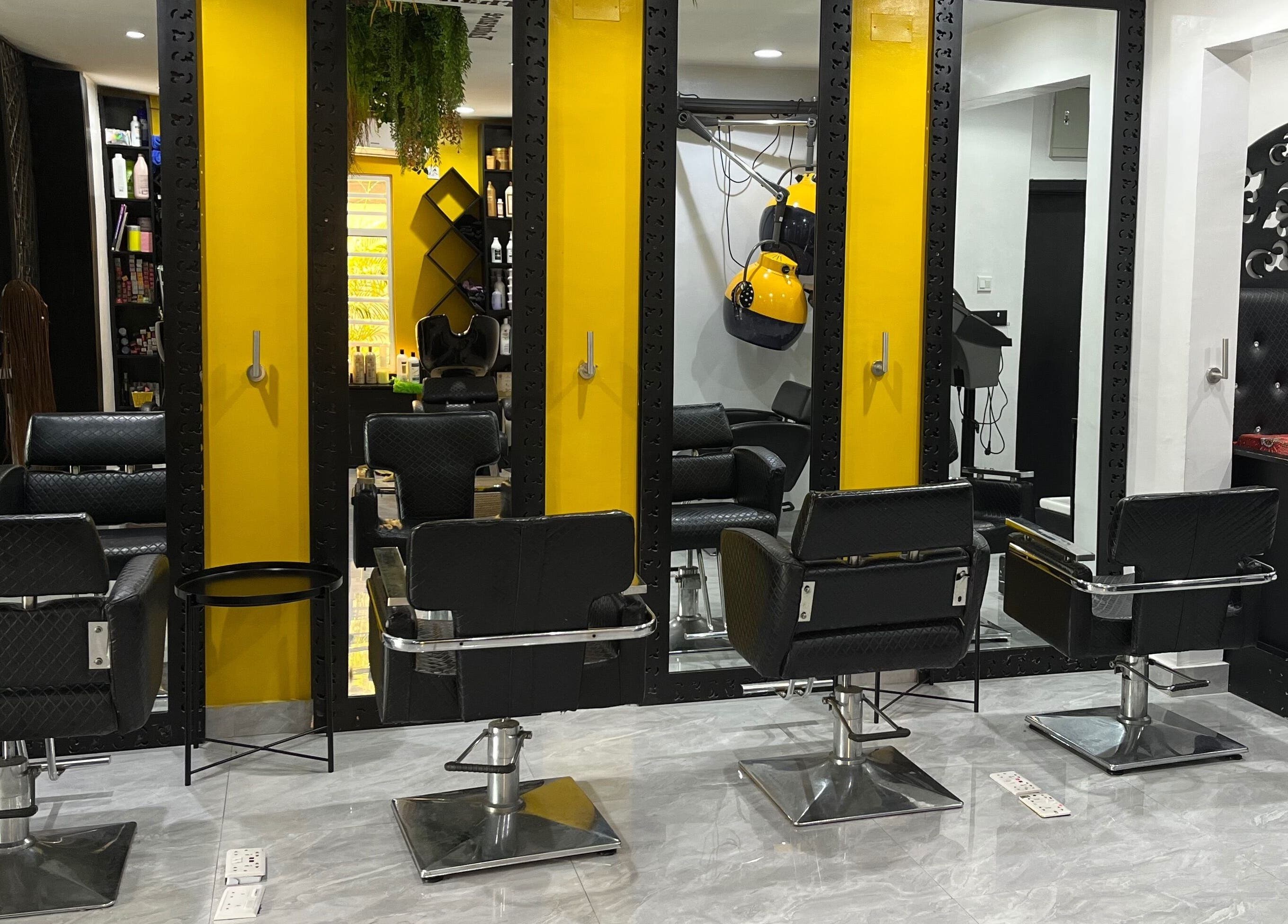Modern salon chairs at Studio M in Lagos, Lagos, NG, with sleek mirrors and vibrant yellow accents.