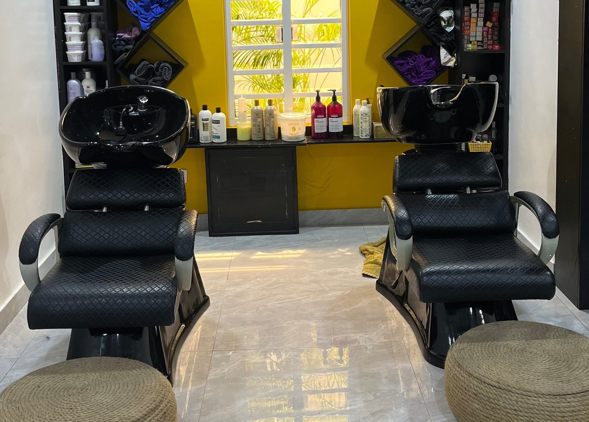 Chic shampoo chairs at Studio M, Lagos, Lagos, NG, offering a relaxing haircare experience.