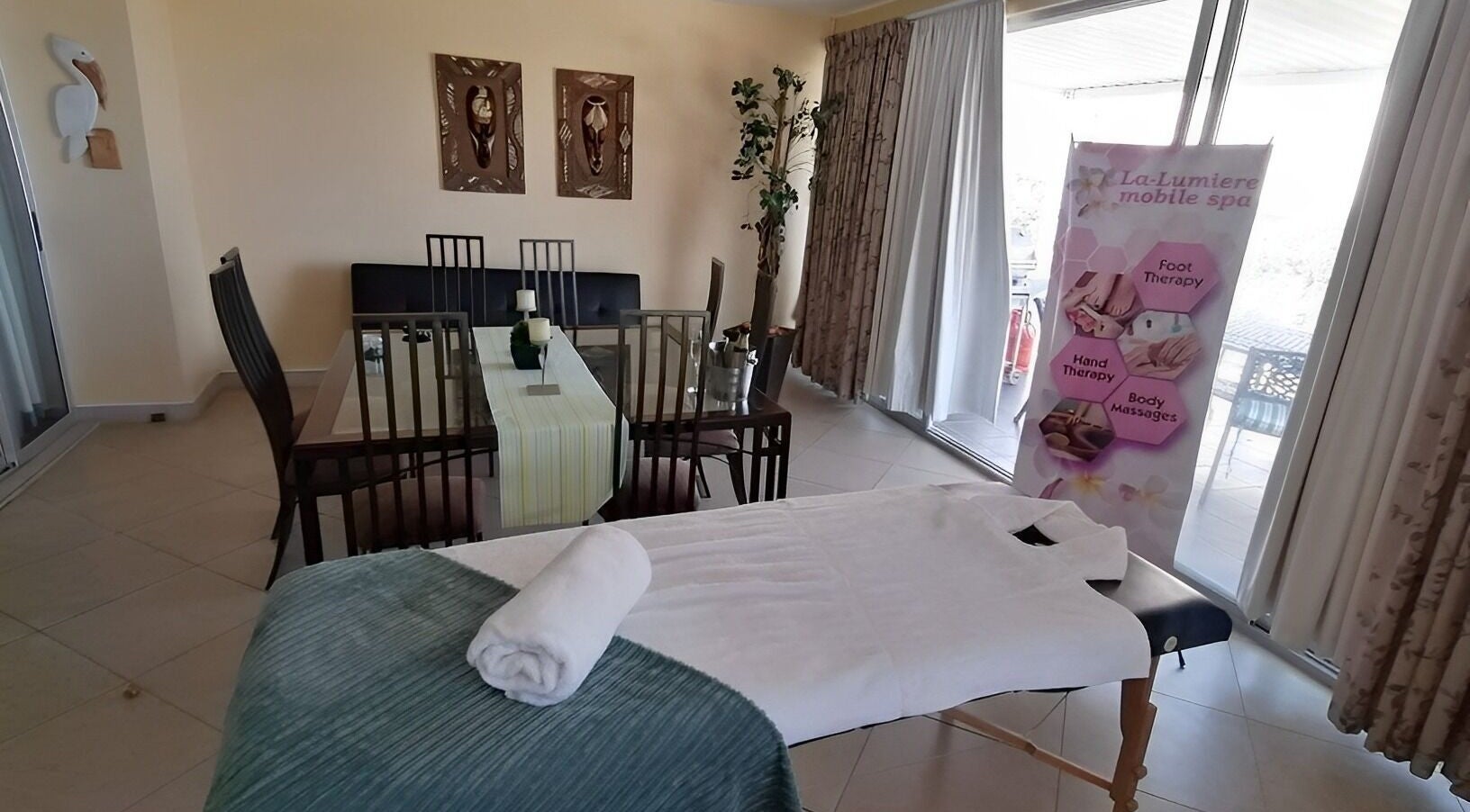 Relaxing treatment area at La-Lumiere Mobile Spa in Margate, Kwazulu-natal, ZA, featuring massage table.