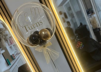 Elegant interior of Hair by Chloe Moore in Paisley, Scotland, GB, featuring a decorative balloon in front of a mirror.