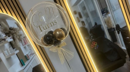 Elegant interior of Hair by Chloe Moore in Paisley, Scotland, GB, featuring a decorative balloon in front of a mirror.