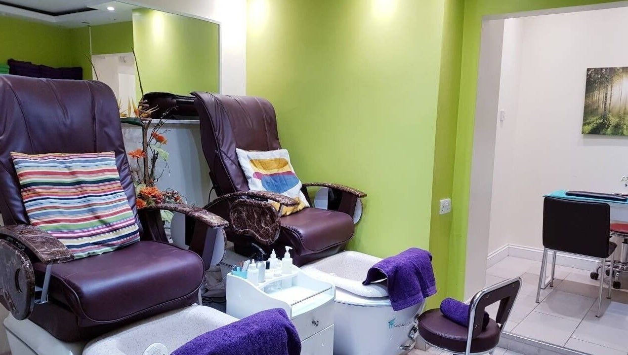 Luxurious pedicure chairs at Absolute Joy Spa, London, England, GB, offering comfort in a vibrant setting.