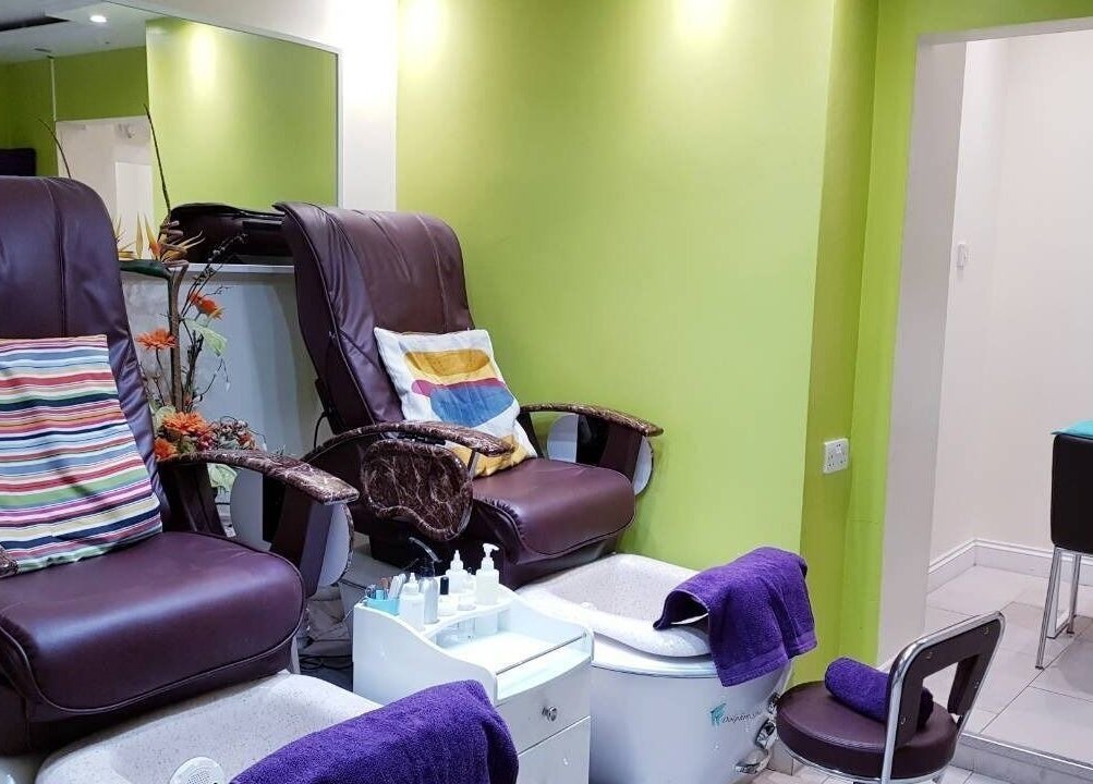 Luxurious pedicure chairs at Absolute Joy Spa, London, England, GB, offering comfort in a vibrant setting.