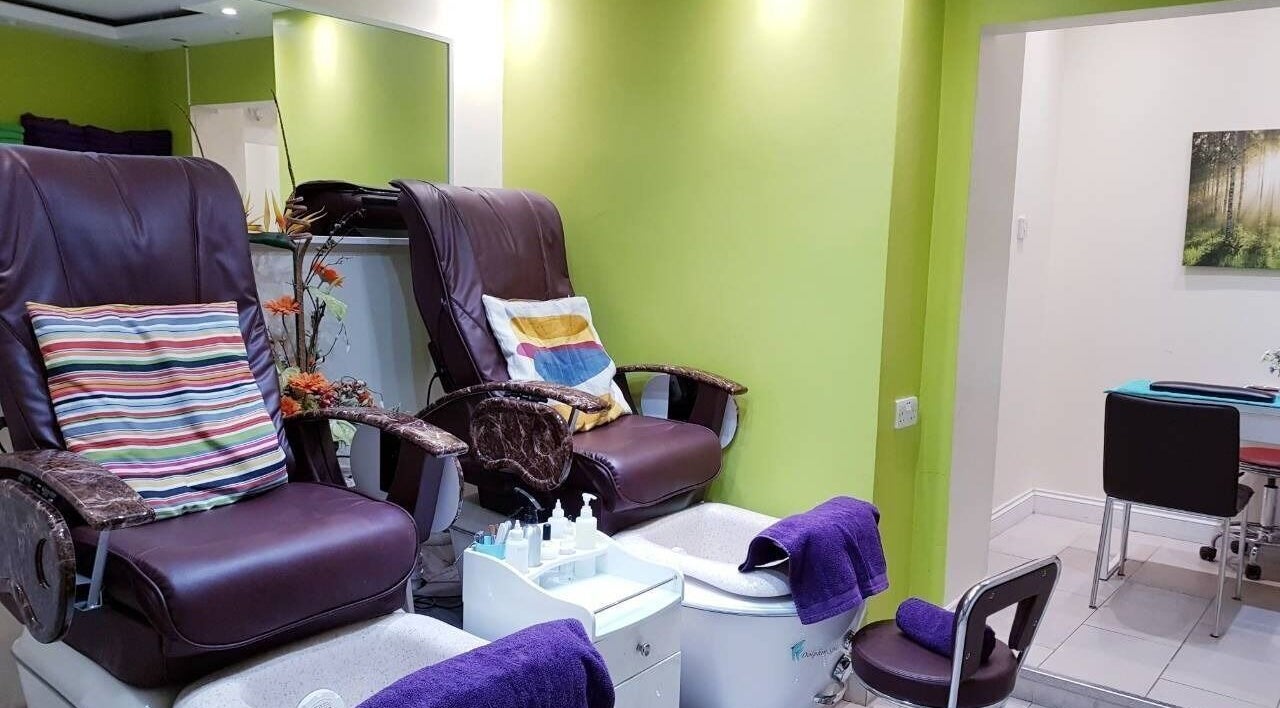 Luxurious pedicure chairs at Absolute Joy Spa, London, England, GB, offering comfort in a vibrant setting.