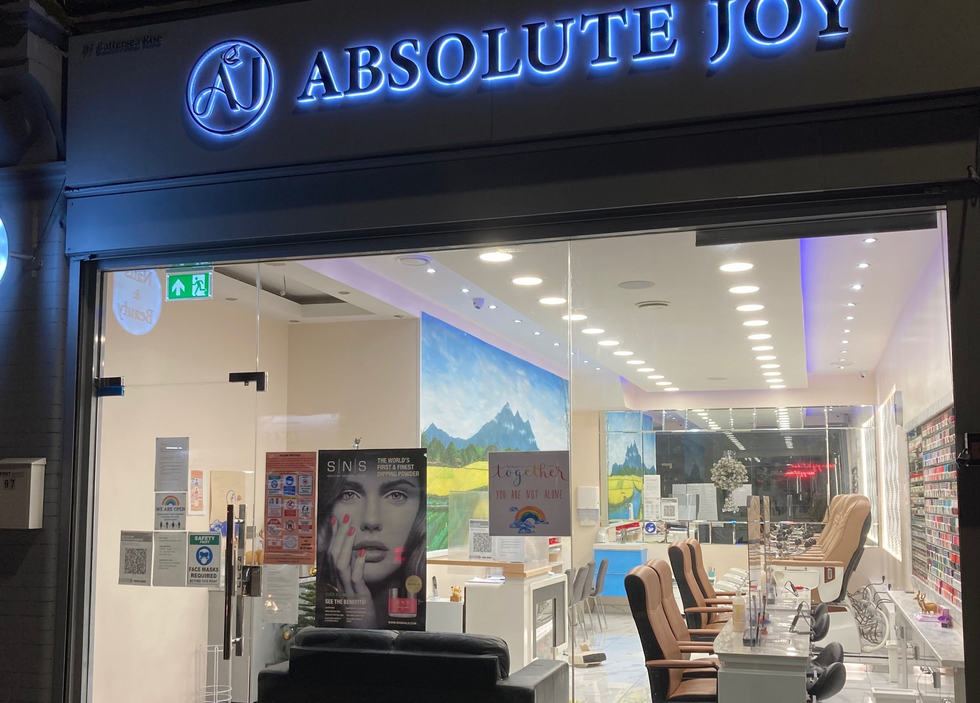 Front of Absolute Joy Spa, London, England, GB, showcasing a stylish wellness venue at night.