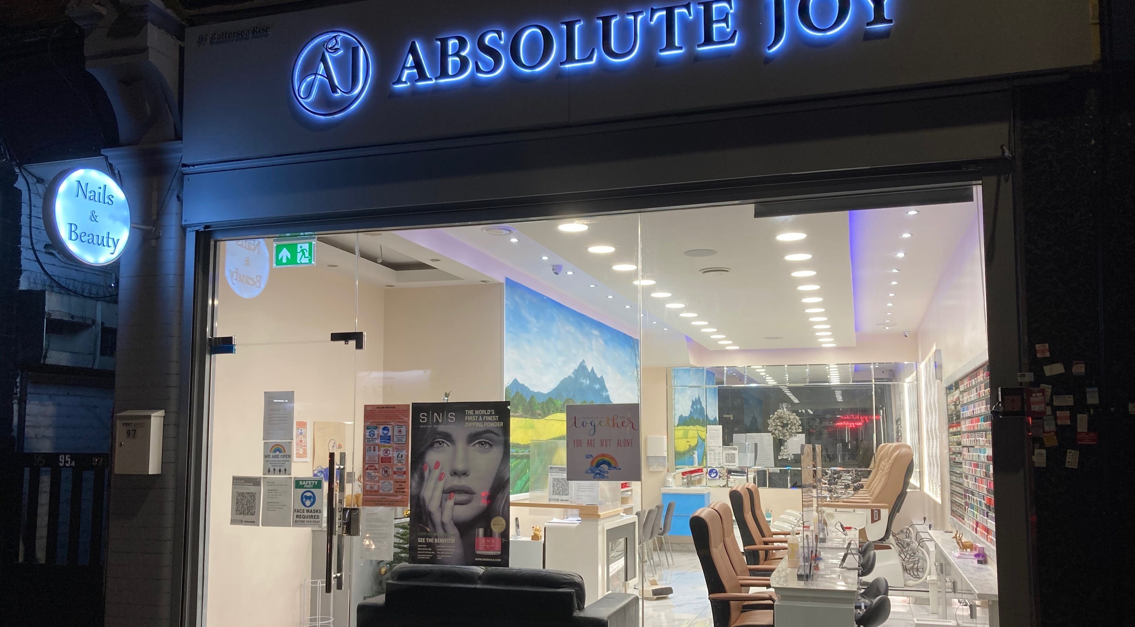 Front of Absolute Joy Spa, London, England, GB, showcasing a stylish wellness venue at night.