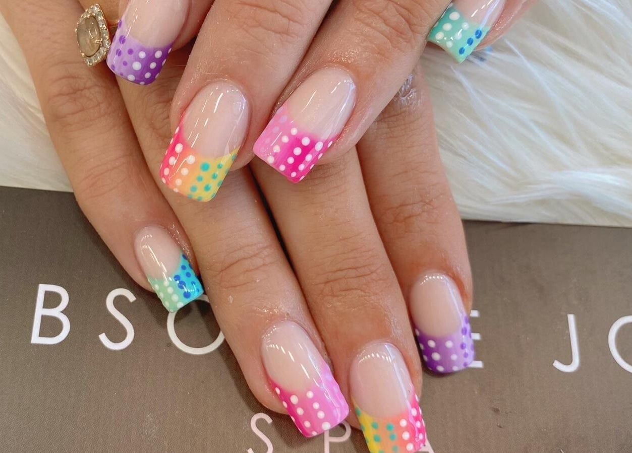 Colorful dotted French nails showcased at Absolute Joy Spa, London, England, GB.