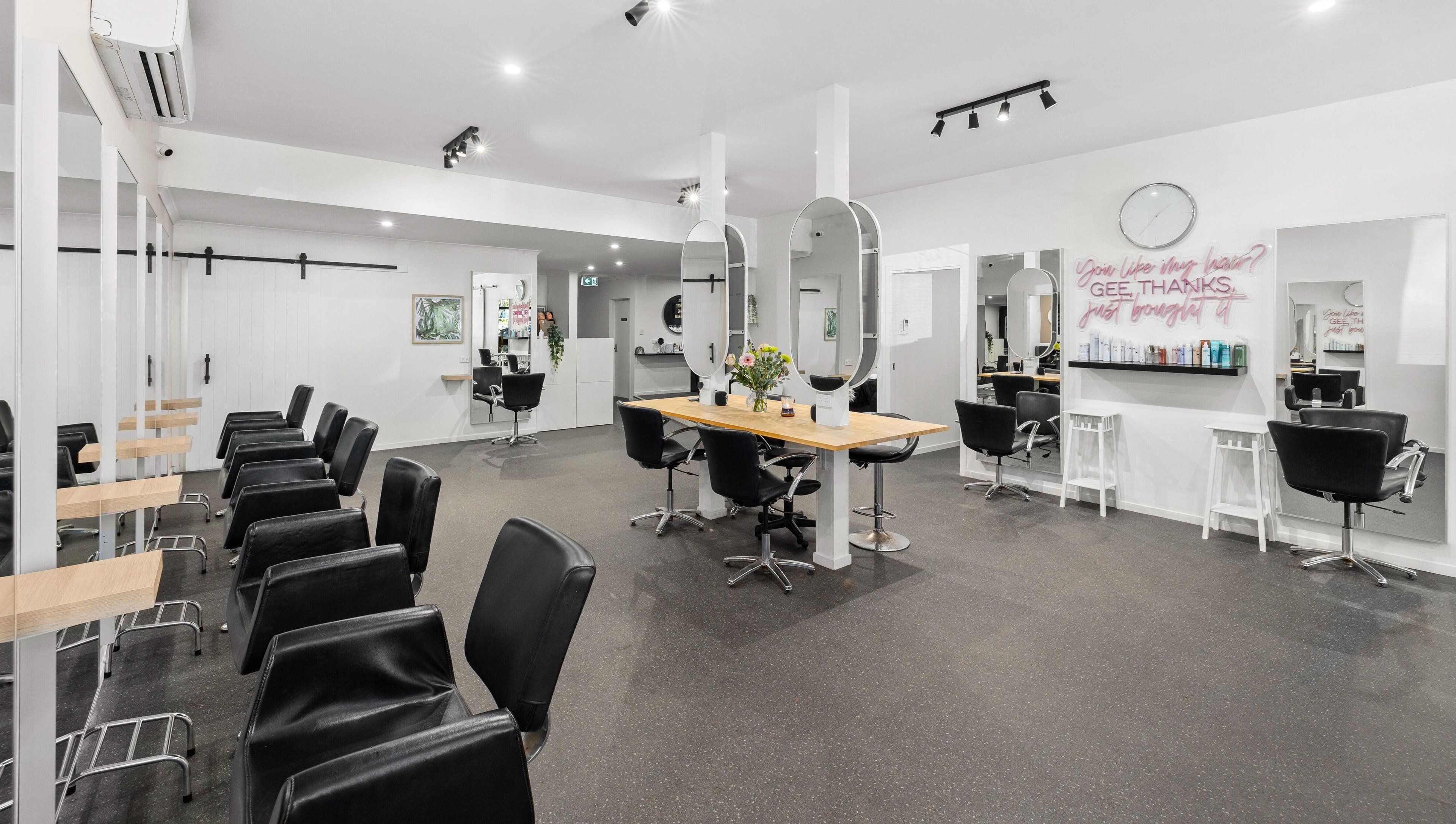 Modern interior of Mane Studioz, Bongaree, Queensland, AU with stylish salon chairs and mirrors.