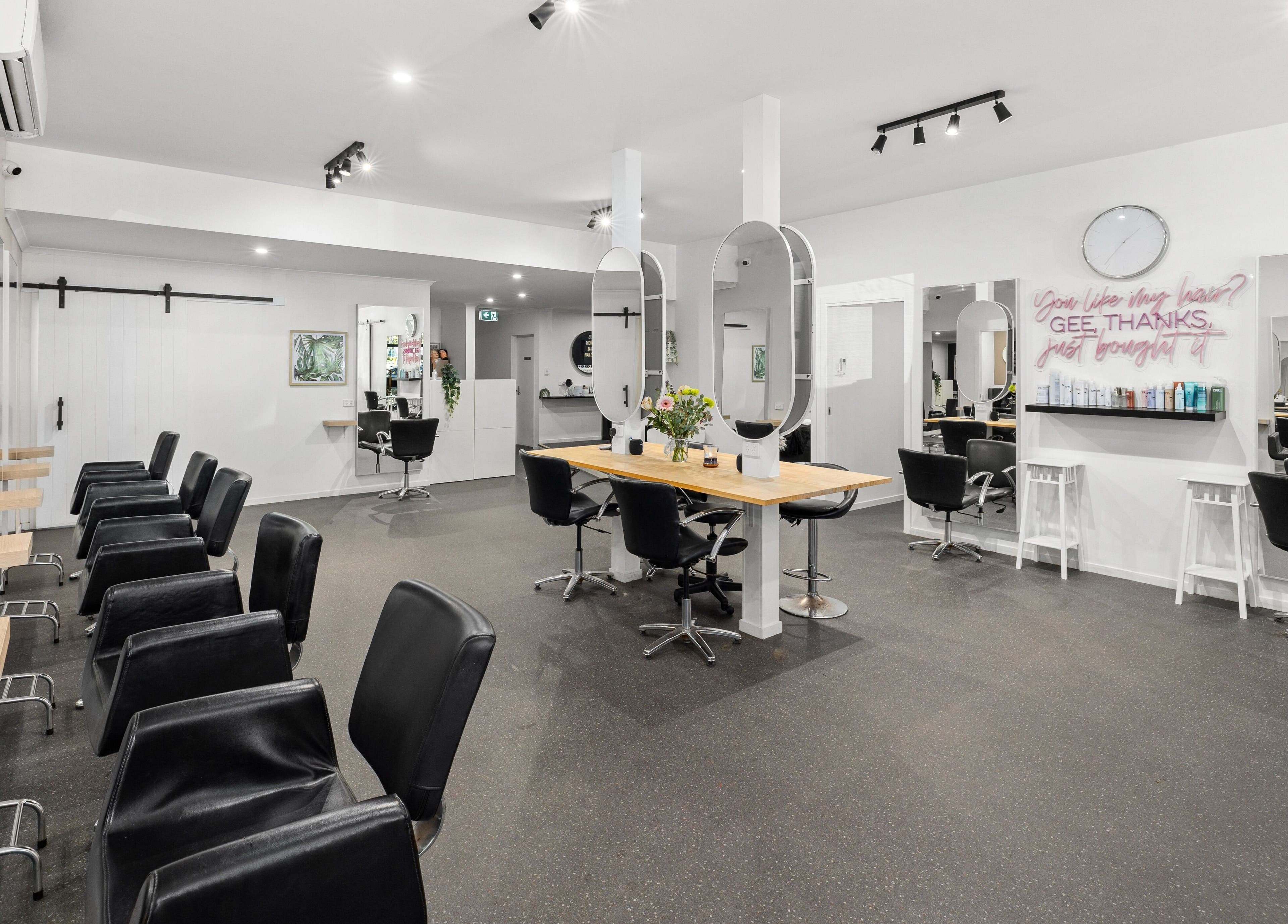 Modern interior of Mane Studioz, Bongaree, Queensland, AU with stylish salon chairs and mirrors.