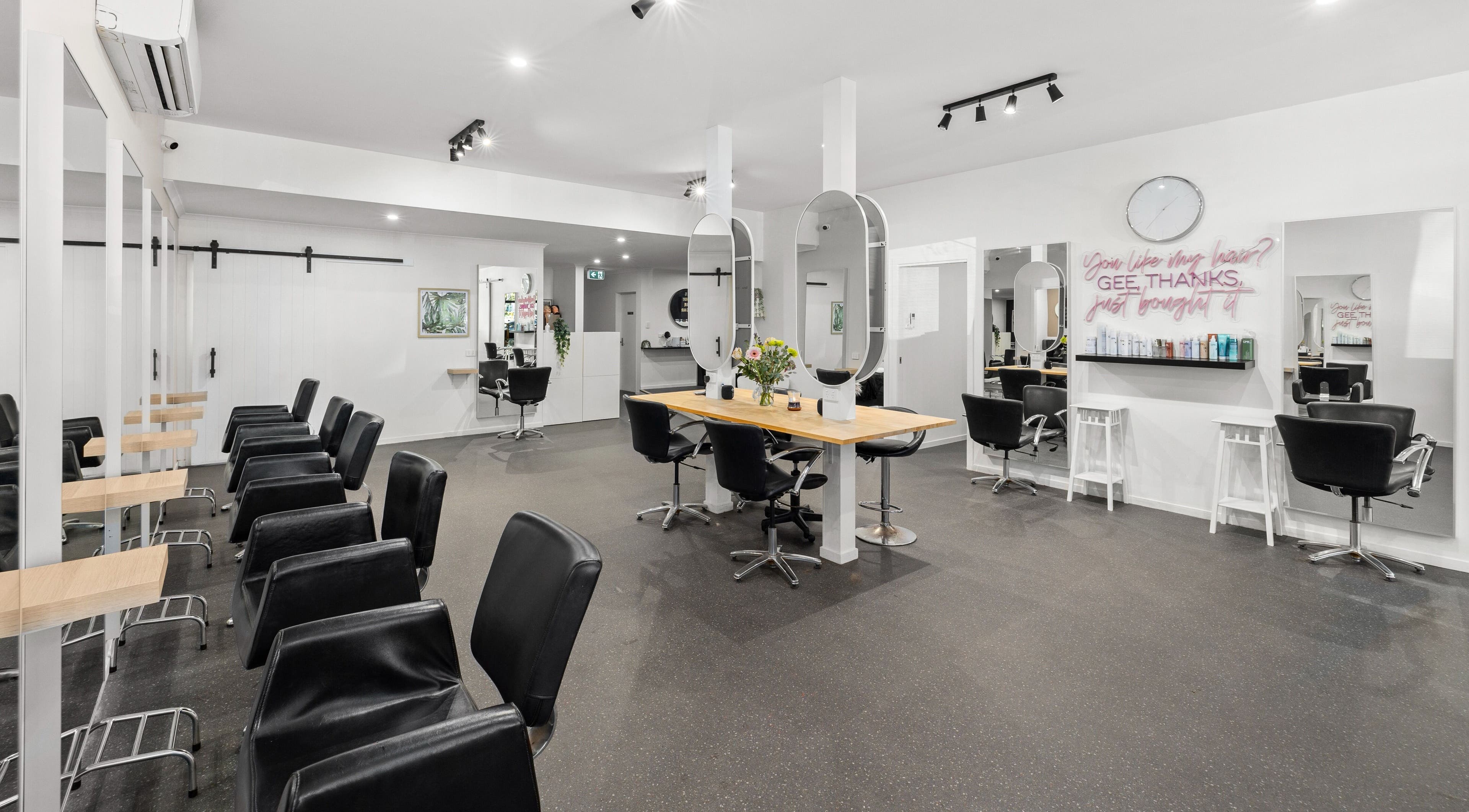 Modern interior of Mane Studioz, Bongaree, Queensland, AU with stylish salon chairs and mirrors.